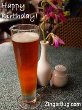 Click here to browse our collection of Happy Birthday comments that feature images of beer, wine and other drinks. This photo features a tall glass of beer with a pink flower nearby. The comment reads: Happy Birthday!