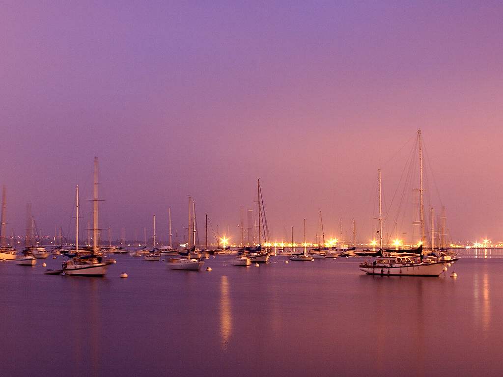 Click to get the codes for this image. Sailboats With Purple Sky And Lights, Ocean  Water, Sunsets and Sunrises, Cars Boats Trains etc Background, wallpaper or texture for any blog, web page, phone or desktop